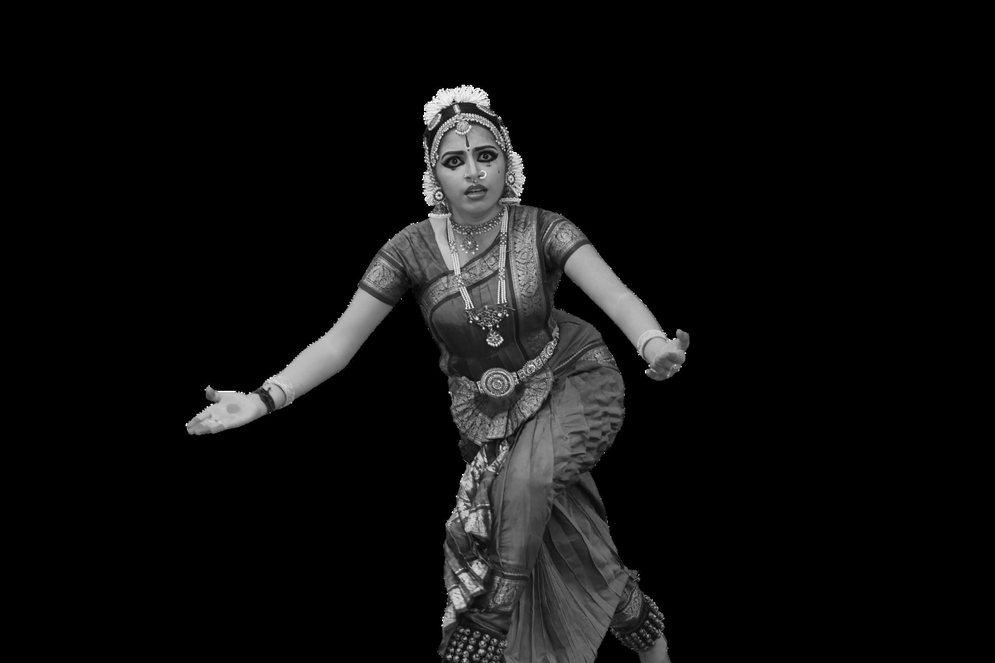 Medha Mayuri in monochrome, mid-pose, isolated against a dark ground.